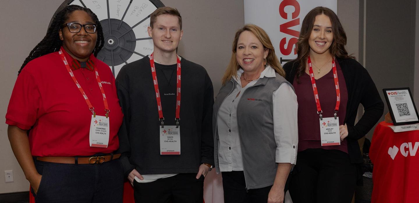 Four recruiters pose in front of the CVS Health booth during an NRF Foundation Career Fair.