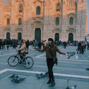 Student posing in front of building in Milan