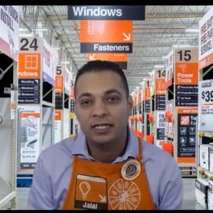 Man in light blue shirt and orange Home Depot apron with Jalal name tag