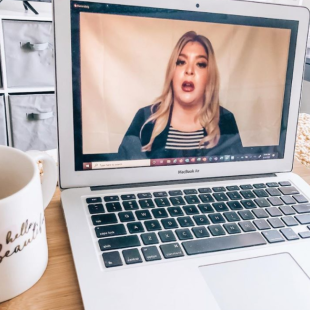 Laptop computer with full screen of female speaking