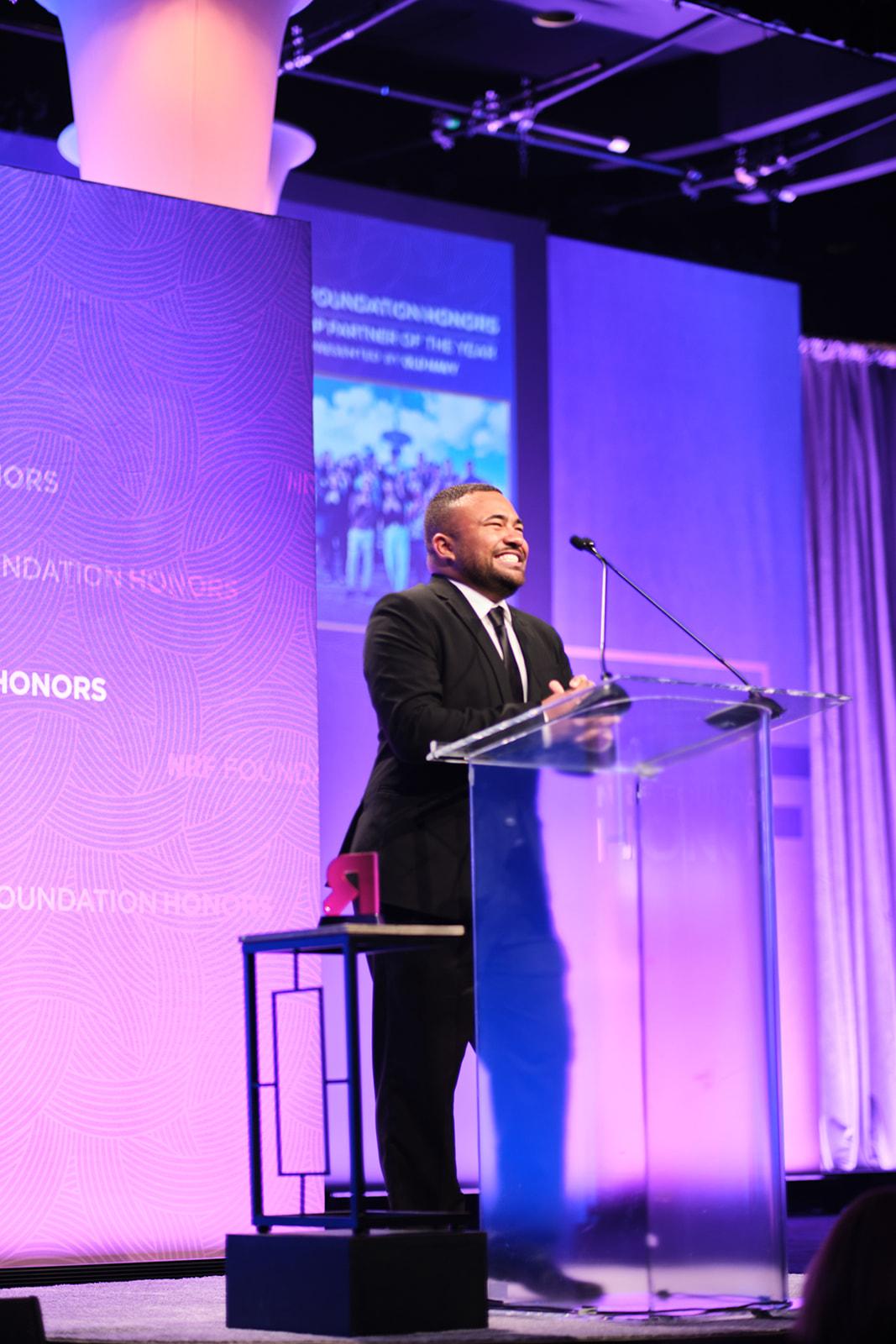 John-Martin Rigsby at the podium onstage at the 2022 NRF Foundation Honors