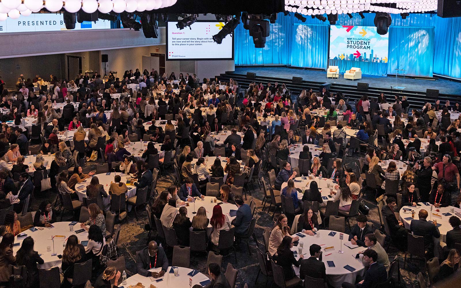 Students sit at tables in a large ballroom during the NRF Foundation Student Program Executive Mentor Experience