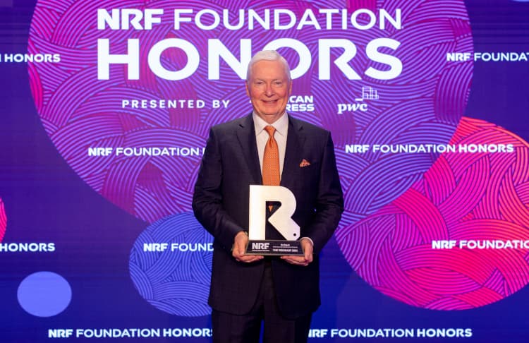 Ed Stack, DICK'S Sporting Goods' Executive Chairman poses in front of a NRF Foundation Honors step-and-repeat with his 2024 Visionary honor