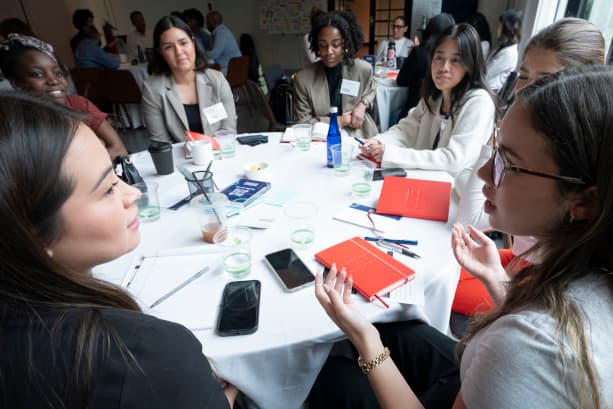 Emerging Leaders Summit attendees having a table discussion during a session.