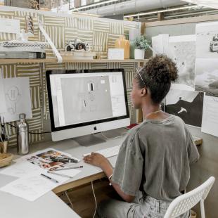 Intern working at computer at desk