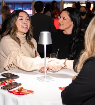 Guests of the Recruiter Networking Reception shake hands