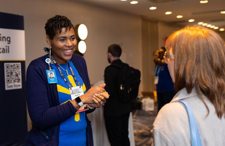 Walmart's Shante Turner speaks to a student at the NRF Foundation Student Program 2023