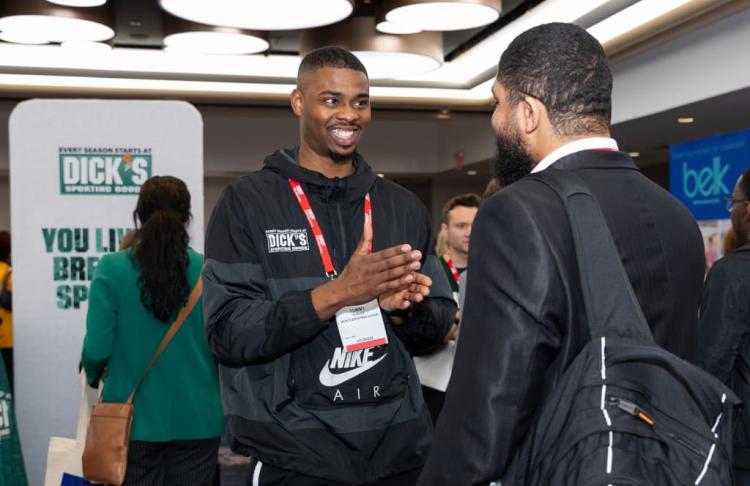 A representative from DICK'S Sporting Goods recruiting team discusses career prospects with an inquiring student.