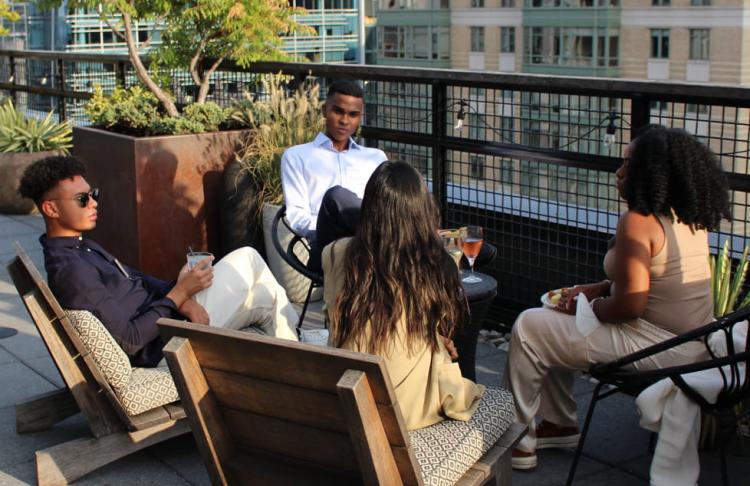 Attendees to the Emerging Leaders Summit chill on the Eaton Hotel rooftop during a Washington D.C. sunset.